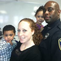 <p>Clinton Jarvis, who was sworn in as a New Canaan Police officer on Tuesday, with his wife, Rachel, and their children, Cameron, at left, and Taylor.</p>