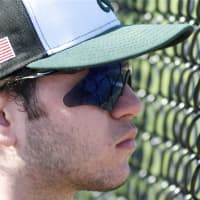 <p>A Yorktown player watches the action from the dugout.</p>