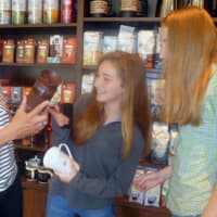 <p>Vicki Weisman, left, checking out coffee mugs at reopened Starbucks with daughters, Natalie, middle and Charlotte</p>