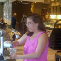 <p>Chloe Rosen of Wilton adding sugar to cup of coffee Friday at renovated Wilton Starbucks</p>
