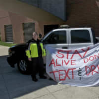 <p>Officers Beth Diiorio (left) and Court Isaac, of the Darien Police Department, deliver a message about texting and driving.</p>