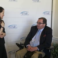 <p>Author Liz Murray chats with a client at the STAR benefit Thursday.</p>
