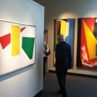<p>Bruce Museum Executive Director Peter Sutton passes by three of Hans Hofmann&#x27;s works on display at the Bruce Museum. He was participating in a lecture on the artist and his works.</p>