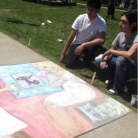 <p>Enrique Silva, left, 20, from Fairfield, and Johan Silva, 19, Bridgeport looking at the work they created at the Sidewalk Arts Festival.</p>