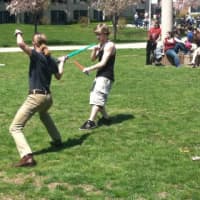 <p>Students engaged in sword play at the Sidewalk Arts Festival.</p>
