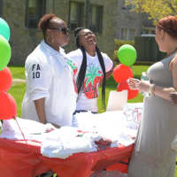 <p>A laugh is shared between volunteers and patrons at The College of New Rochelle&#x27;s Strawberry Festival.</p>