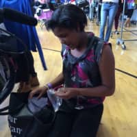 <p>A teen girl checks out some of the items at the boutique.</p>