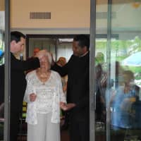 <p>Millie getting a blessing from Father Chris and Father George.</p>
