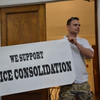 <p>Mount Kisco policemen hold a pro-consolidation banner.</p>