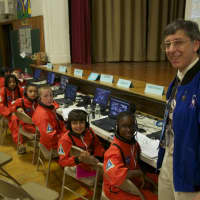 <p>Commander in Chief, and fourth-grade teacher, Andy Pearce stands at Mission Control.</p>