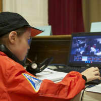 <p>Students at Mission Control keep an eye on the mission in progress.</p>