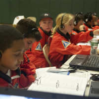 <p>Students at Mission Control keep an eye on the mission in progress at Columbus Magnet School in Norwalk.</p>