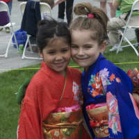 <p>Seven-year-old Jaimie Corpuz (left) and Ava Tarnacki, 6, both of Stamford, in kimonos at the Cherry Blossom Festival in Stamford on Saturday.</p>