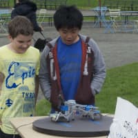 <p>Kids watch the &#x27;Robot Battle Competition&quot; exhibit.</p>