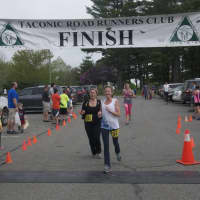 <p>Runners cross the finish line at the Mother&#x27;s Day 5K and two-mile walk.</p>