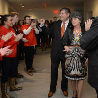<p>Frank Martire and his wife Marisa get applause from Sacred Heart University students.</p>