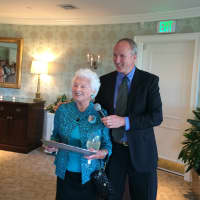 <p>Alice Mae Orr receives a plaque from Board President M. Reese Hutchison for 50 years as a Darien Realtor.</p>