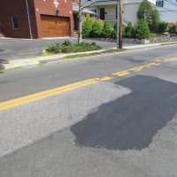 <p>This stretch of Park Aenue in Harrison remained pitted by deep potholes last week .By Tuesday May 12, public works crews had filled them with fresh asphalt. </p>
