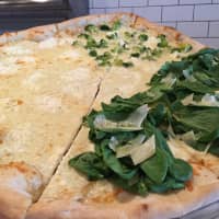 <p>Popeye&#x27;s White pizza with spinach.</p>