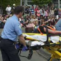<p>Paramedics tend to a crash &quot;victim.&quot;</p>