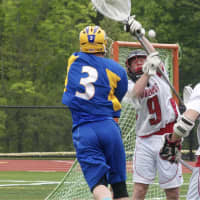 <p>Danny Foley (3) of Mahopac puts a ball in the goal in a 7-6 win over top seed Fox Lane. </p>