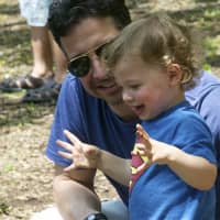 <p>Jes Santoro and his 2-year-old son, Chase, of Darien, play near the waterfront Sunday at the Spring on the Farm Festival.</p>