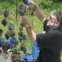 <p>An artist sets up a display at the crafts festival.</p>