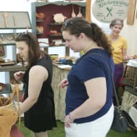<p>Festival-goers check out a kitchenware display at the Outdoor Crafts Festival last year at the Bruce Museum in Greenwich.</p>