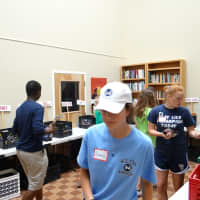 <p>Wilton High School student volunteers sort donated food in Norwalk.</p>