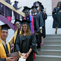 <p>Graduating students fill the staircase. </p>