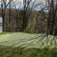 <p>There is a 3-hole putting green with sand trap in the backyard. </p>