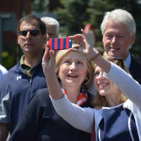 <p>Hillary Clinton pauses for what looks like a selfie attempt.</p>