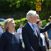 <p>Bill Clinton waves while marching in downtown Chappaqua, with New Castle Supervisor Rob Greenstein walking with him.</p>