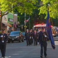<p>Firefighters and Apparatus marching down Purchase St.</p>