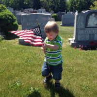 <p>Michael Richards, 2, places flags at St. Mary&#x27;s Cemetery on Memorial Day with his grandpa Charlie Sacco of the Port Chester Knights of Columbus.</p>