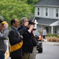 <p>Parade participants give salutes during a stop in front of the Bedford Hills Community House.</p>