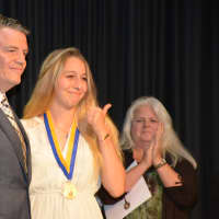 <p>Lewisboro resident Riley DeJong (right) with her medal. State Sen. Terrence Murphy is pictured at left.</p>
