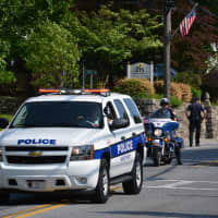 <p>A Mount Kisco police vehicle leads the procession for the local Memorial Day parade.</p>