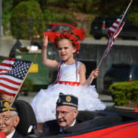 <p>Bianca Weiss, this year&#x27;s poppy girl, waves out of a car in Mount Kisco&#x27;s Memorial Day parade. </p>