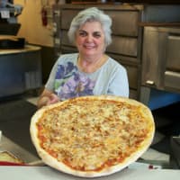 <p>Pasquale Trattoria owner Elsa Albanese with one of her pies.</p>