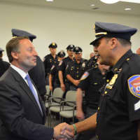 <p>Westchester County Executive Rob Astorino shakes hands with a former Mount Kisco policeman who has joined the county police.</p>