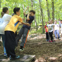 <p>Teamwork keeps the Columbus Elementary School group safely on the platform at Taconic Outdoor Education Center in Cold Spring.</p>