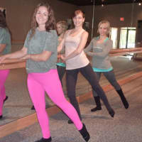 <p>In the Pure Barre workout, participants line up at the traditional ballet barre. </p>