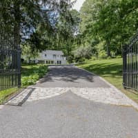<p>An iron gate welcomes residents and visitors onto the over 2-acre property.</p>