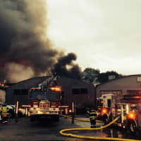 <p>Warehouses at the former yard of Fairfield Lumber burn late Tuesday.</p>