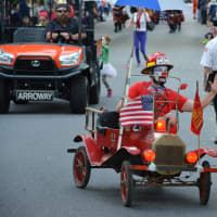 <p>A firefighter-style clown rides in the Katonah parade.</p>