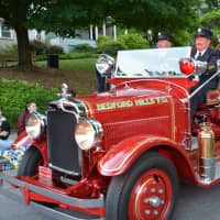 <p>An antique Bedford Hills firetruck makes a parade appearance in Katonah.</p>