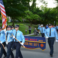 <p>Pound Ridge firefighters march in the Katonah parade.</p>
