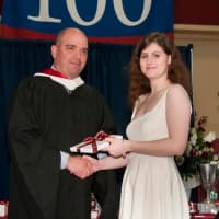 <p>Harvey Upper School Head Phil Lazzaro, left, presents Mary Nichols of Greenwich with one of the five major academic prizes she received at the Katonah, N.Y. schools graduation ceremony.</p>