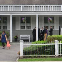 <p>Mourners outside of Graham Funeral Home in Rye on Saturday.</p>
